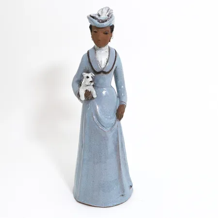 Figurin av Margareta Bourelius, kvinna med hund, höjd ca 43 cm, lergods, signerad Vikt: 0 g Skickas med postpaket.