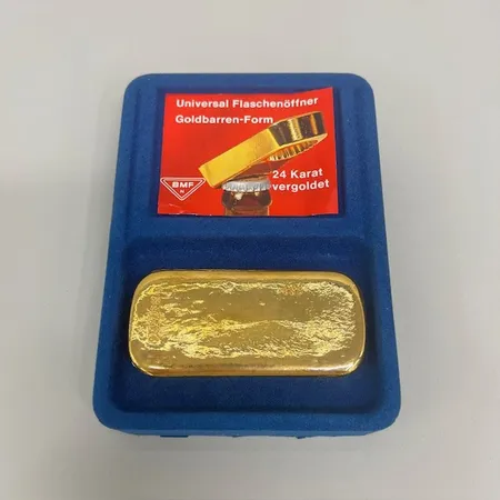 Kapsylöppnare i form av en guldtacka, längd ca 8,5cm, BMF Tyskland 24 karats guldförgyllning, originalask