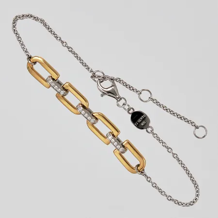 Armband Ti sento med vita stenar med förgyllda delar längd ca 16-19,8cm bredd ca 1-6mm  Vikt: 4,4 g