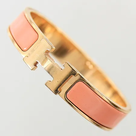 Armband Hermés Clic H gulmetall med persikofärgad emalj 55x45mm bredd 12mm emalj med slitage/nagg gulmetall med repor kvitto från NK dustbag etui