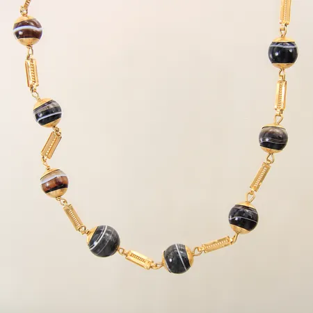 Collier med troligen bandagat längd ca 150cm, bredd 4,7-13,7mm, slitna stenar/nagg, bucklor ostämplad 18K bruttovikt: 150,6g Vikt: 150,6 g