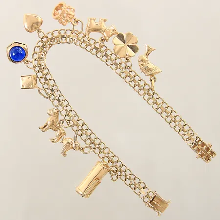 Armband X-länk med tio berlocker längd 18cm, bredd 6-10mm 18K  Vikt: 16,3 g