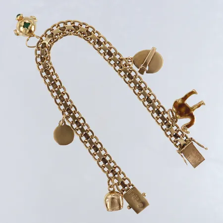 Armband X-länk med fem berlocker längd 19cm bredd 7,5mm 18K.  Vikt: 24,9 g