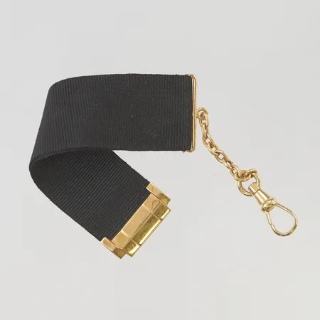 Klocklänk med tygband 13,5cm, 18K bruttovikt 5,9g.