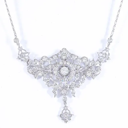 Vackert collier i silver med gnistrande vita stenar i ett fast mittparti. Dekoren är ca 10 x 6 cm. Längd 43 cm. Vikt: 23,2g.
