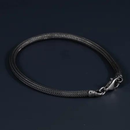Oanvänt halvstelt armband i oxiderat silver 925/1000. Längd 18,5 cm, Ø 3 mm. Karbinhake. 4,4g.