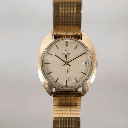 Herrur Eterna Quartz guld på stål. Ø35,5mm datum. med gravyr går ej, ej funktionstestad
