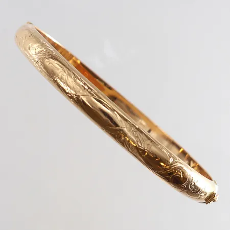 Armring med dekor öppningsbar Ø64mm bredd 7mm bucklig 18K.  Vikt: 10,9 g