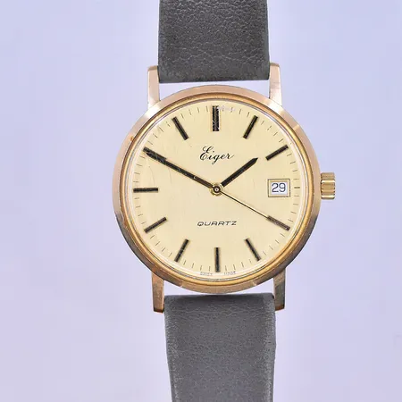 Herrur Eiger quartz datum Ø35 mm, graverad boett 14K.