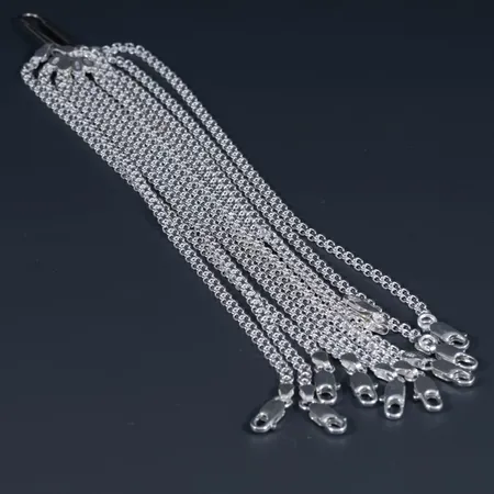 Tio likadana oanvända armband x-länk i silver 925/1000. Längd 18 cm, bredd 3,3 mm. Karbinhake. Totalt 34,0g.