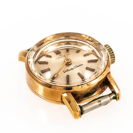 Damur Helvetia Lady Swiss guld 18K manuell Ø18,5mm, safirglas, saknar urband, bucklig baksida, går ej. Bruttovikt:8,7g.