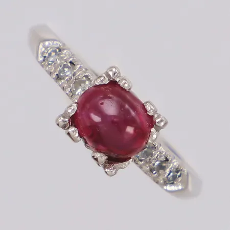 Ring med rubin och diamanter 6xca 0,02ct, stl:17½, bredd 6mm, vitguld, nagg, lagad skena, ostämplad, platina Vikt: 4,4 g