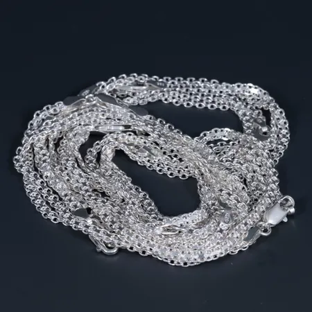 12 oanvända armband x-länk i silver 925/1000. Längd 19 cm, bredd 3,3 mm. Karbinhake. Totalt 42,8g.