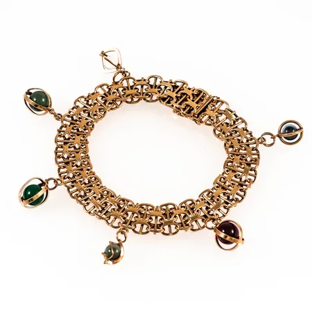 Armband X-länk med 6 berlocker längd 20cm bredd 11,5mm, 18K 30,9g.