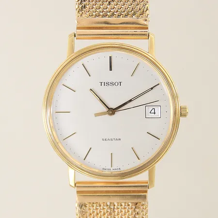 Herrur Tissot Seastar 18K, quartz, Ø34mm, datum, bucklig länk i 18K, plexiglas, behov av batteribyte, manual, gravyr, box. Bruttovikt: 56,1g