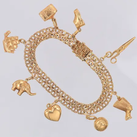 Armband Bismarck längd 18,2cm bredd 8mm 8 berlocker, en låsåtta något defekt, 18K Vikt: 20,5 g