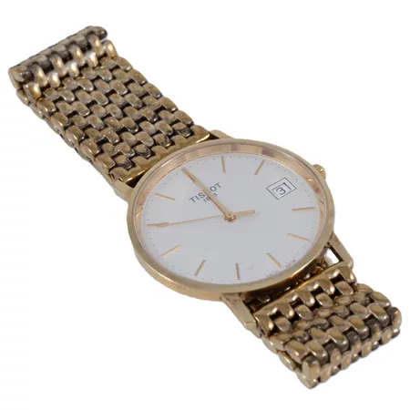 Herrur Tissot 1853 guld 18K quartz 33,5mm datum, safirglas, länk i gulmetall längd 18/18,5cm, gravyr, defekt krona, går ej att ställa. Går ej - Batteribyte krävs? Bruttovikt:70,8g.