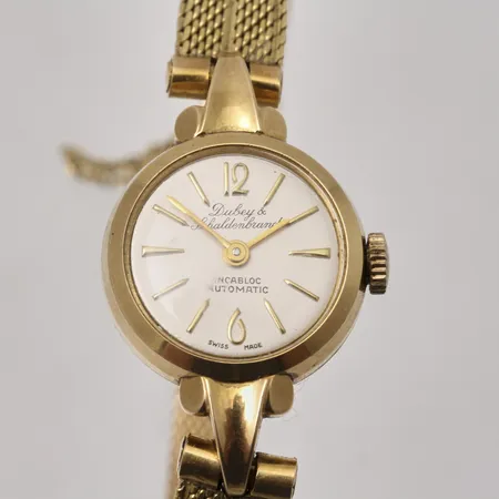 Damur Dubey & Schaldenbrand i 18K guld, automat, Ø18mm, integrerad länk i 18K guld, handledsmått inklusive ur 17,2, säkerhetskedja, bruttovikt.