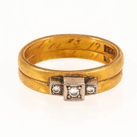 Ring med tre briljantslipade diamanter totalt 0,07ct stl:16½ bredd 4,9mm, två ihoplödda ringar i 23K, fattning i vitguld 18K. Gravyr. Vikt 5,9g.