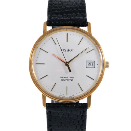 Herrur Tissot Seastar Quartz guld 18K 33,5mm, datum, plexiglas, svart läderband, framstår oanvänd, gravyr företagslogga 25år, Går ej - Batteribyte krävs? Bruttovikt: 28,6g.