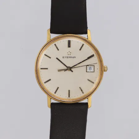 Herrur Eterna, Ø33,4mm, quartz, datum, gravyr år 1991, sliten krona, läderband, 18K