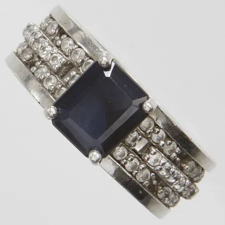 Ring med en blå samt vita stenar, stl:19, bredd: 8,4-9mm, ostämplad, silver Vikt: 9,7 g