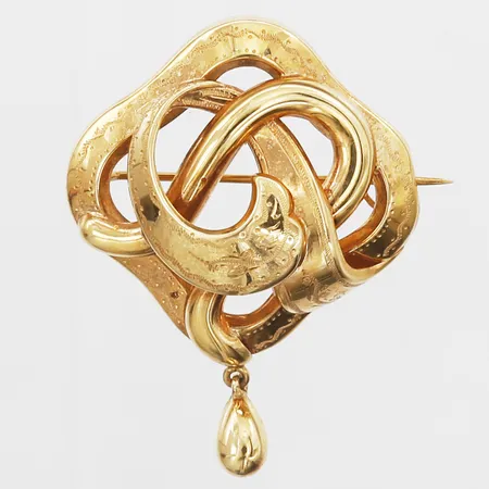 Brosch med dekor i relief, längd inkl. berlock 44mm, bredd 33mm, Guldvaruaktiebolaget G. Dahlgren & Co AB, Malmö 1953, defekt låsåtta, 18K. Vikt: 4,8 g