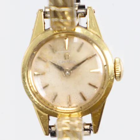 Damur Omega 18K Ø17mm manuell uppdragning, ca år 1960, gravyr, urtavla med slitage, flexlänk bruttovikt 14,1g