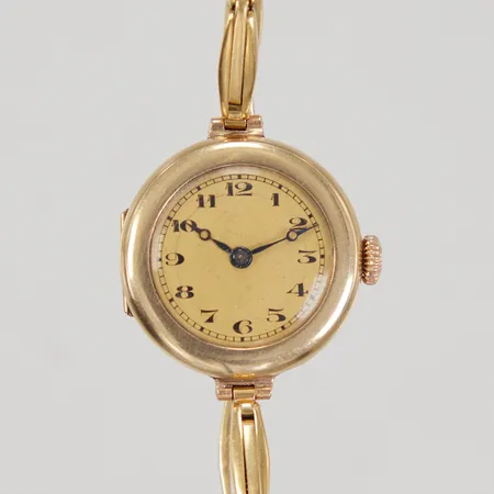 Ett äldre damur Ø ca 23mm, manuell, 14K med doublélänk bruttovikt: 16,5g