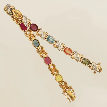 Armband med flerfärgade safirer samt rubin samt diamanter ca 32x ca 0,01ct, längd 15cm bredd 5,8mm, ostämplad 18K Vikt: 14,2 g