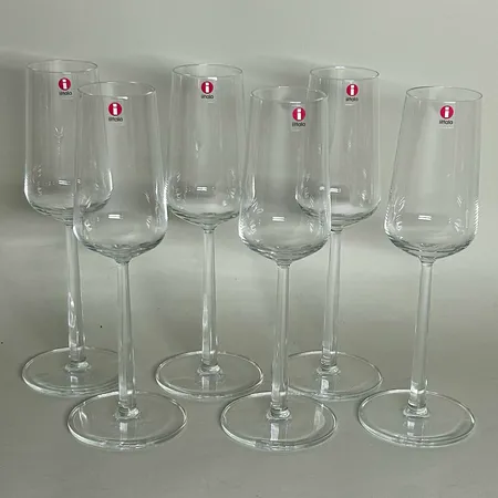 6st Champagneglas Iittala Essence design Alfredo Häberli 2001, klarglas, höjd 23cm, 21cl per glas, etikettmärkta, tre vita skadade originalförpackningar Skickas med postpaket.