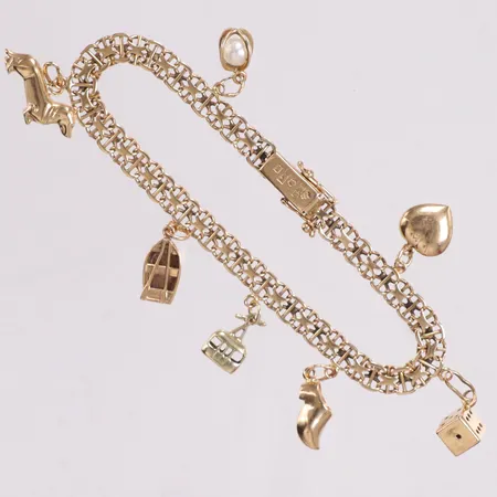 Armband X-länk med stav med 7 berlocker längd 19cm bredd 5,2mm 18K Vikt: 13,1 g
