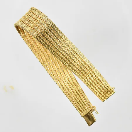 Armband halvstel modell längd 19 cm, bredd 14-18 mm, buckligt, klämskador, 18K. Vikt: 34,7 g