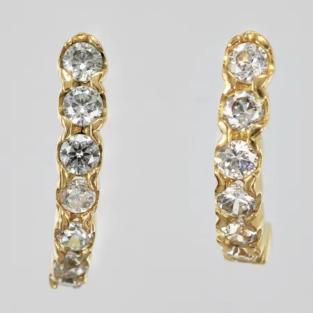 Ett par örhängen med vita stenar stoppers saknas längd: ca 1,3cm bredd: ca 3mm 18K Vikt: 2,4 g