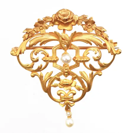 Brosch med pärlor och vit sten, längd 41,7mm, bredd 2,1-37,6mm, pärlor Ø3,4mm, 18K. Vikt: 6 g