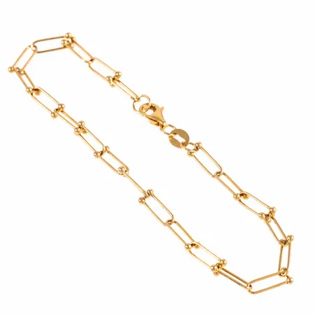 Armband i 18K guld. Det är 17,5 cm långt, 0,5 - 3 mm brett och väger 2,1g. Karbinhake.