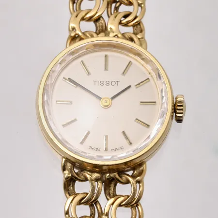 Damur Tissot i 18K guld, Ø21mm, manuell, integrerad Bismarcklänk i 18K guld med kistlås, handledsmått inklusive ur 17cm, bruttovikt 29,35g, ca nettovikt 22g.