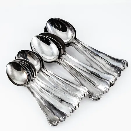 Parti silver (830/1000) modell Symfoni: 12 bordsgafflar (170 mm), 12 bordsskedar (170 mm), 12 dessertskedar (145 mm), 11 smörgåsgafflar (147 mm), 12 smörgåsknivar med rostfria blad (170 mm), 12 bordsknivar med rostfria blad (195 mm), 2 smörknivar med rostfria blad (145 mm), 2 ostknivar med rostfria blad (150 mm). De fyllda delarna med rostfria blad väger 928g bto. Totalvikt ca 2350g. Alla MEMA från 1960-talet. Bruksskick, repor, olika monogramgravyr på alla delar. Skickas med postpaket.