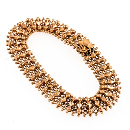 Armband Fantasilänk i 18K guld. Det är 19 cm långt, 12,5 mm brett och väger 17,9g. Kistlås. Ojämnheter.