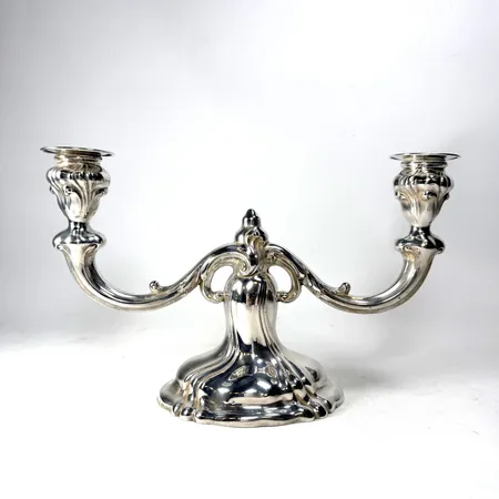 Tvåarmad ljusstake, tyska stämplar "WIB", svensk importstämpel, 1900-tal, höjd 18cm,  tidigare fylld fot, rester kvar från urbankat gips, silver 830/1000 Vikt: 297,8 g