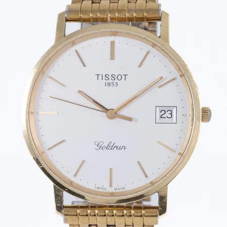 Herrur Tissot Goldrun i 18K guld med band i förgylld metall. Boett Ø 33,5 mm, datum, quartz, safirglas, gravyr "För nit och redlighet i rikets tjänst". Går ej- batteribyte krävs?