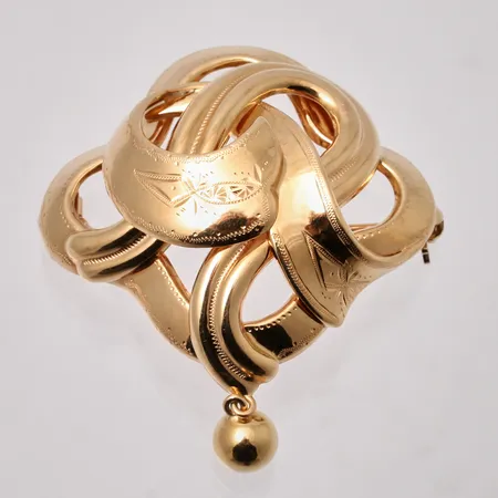 Bosch i 18K guld, mått 39,4x48mm, tillverkad av Guldvaruaktiebolaget G. Dahlgren & Co Ab, år 1944, vikt 6,64g.