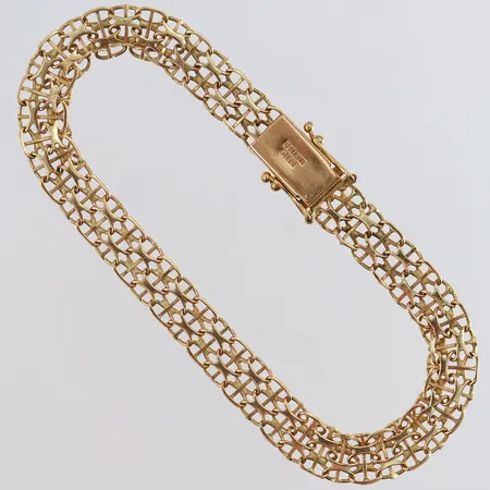 Armband X-länk med stav längd 19cm bredd 7mm skadade länkar 18K. Vikt: 8,5 g