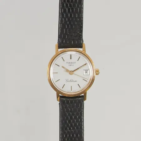 Damur Tissot Goldrun 18K Ø22mm, kvarts, läderband, totala längd 20,5cm, batteribyte krävs, personlig gravyr, originaletui.