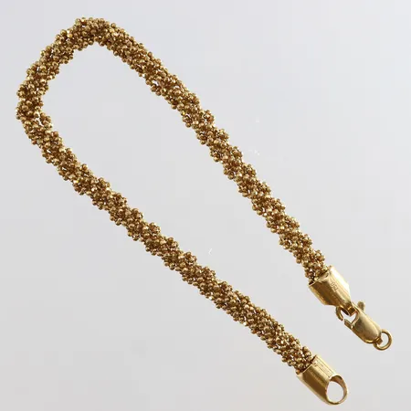 Armband längd 19,5cm bredd 4,5mm ojämn defekt låsögla 18K.  Vikt: 13,6 g