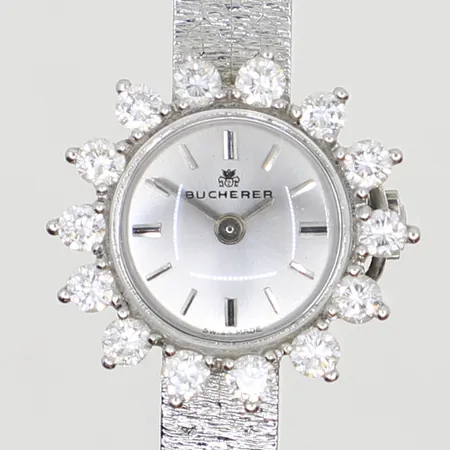 Damur Bucherer med diamantkrans 14x ca 0,07ct 16cm Ø21mm vitguld länk samt boett i 18K, längd ca 15cm, med garantibevis 1976, vitguld 18K Bruttovikt: 25g