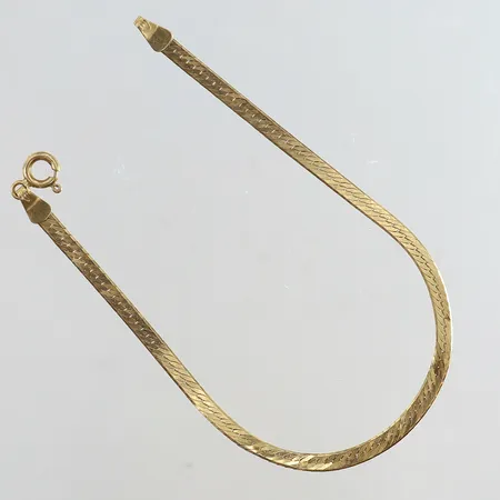 Armband längd 18cm bredd 3mm bucklig 18K. Vikt: 3,4 g