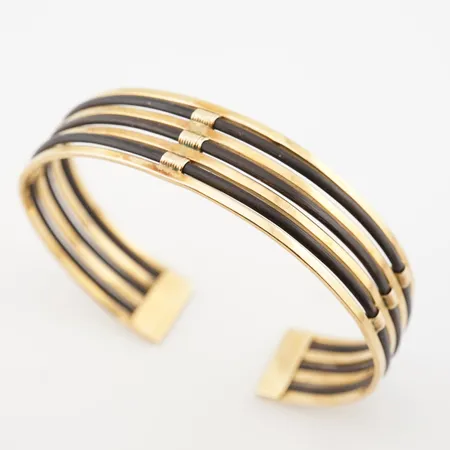 Armring m läderdetaljer, innermått 18cm, bredd 14mm, 18k Vikt: 19,4 g