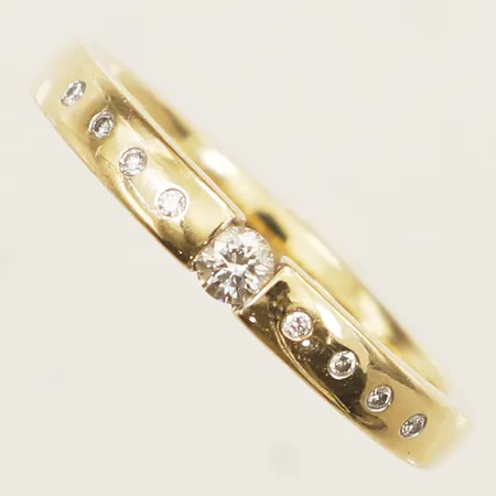 Ring med diamanter 1x0,10ct samt 8x0,005ct stl:19½ bredd 2,9mm 18K Vikt: 4,9 g