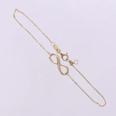 Armband med evighetsteckan längd ca 18cm, bredd 0,9-6,1mm, knut, GHA, 18K.  Vikt: 1,4 g